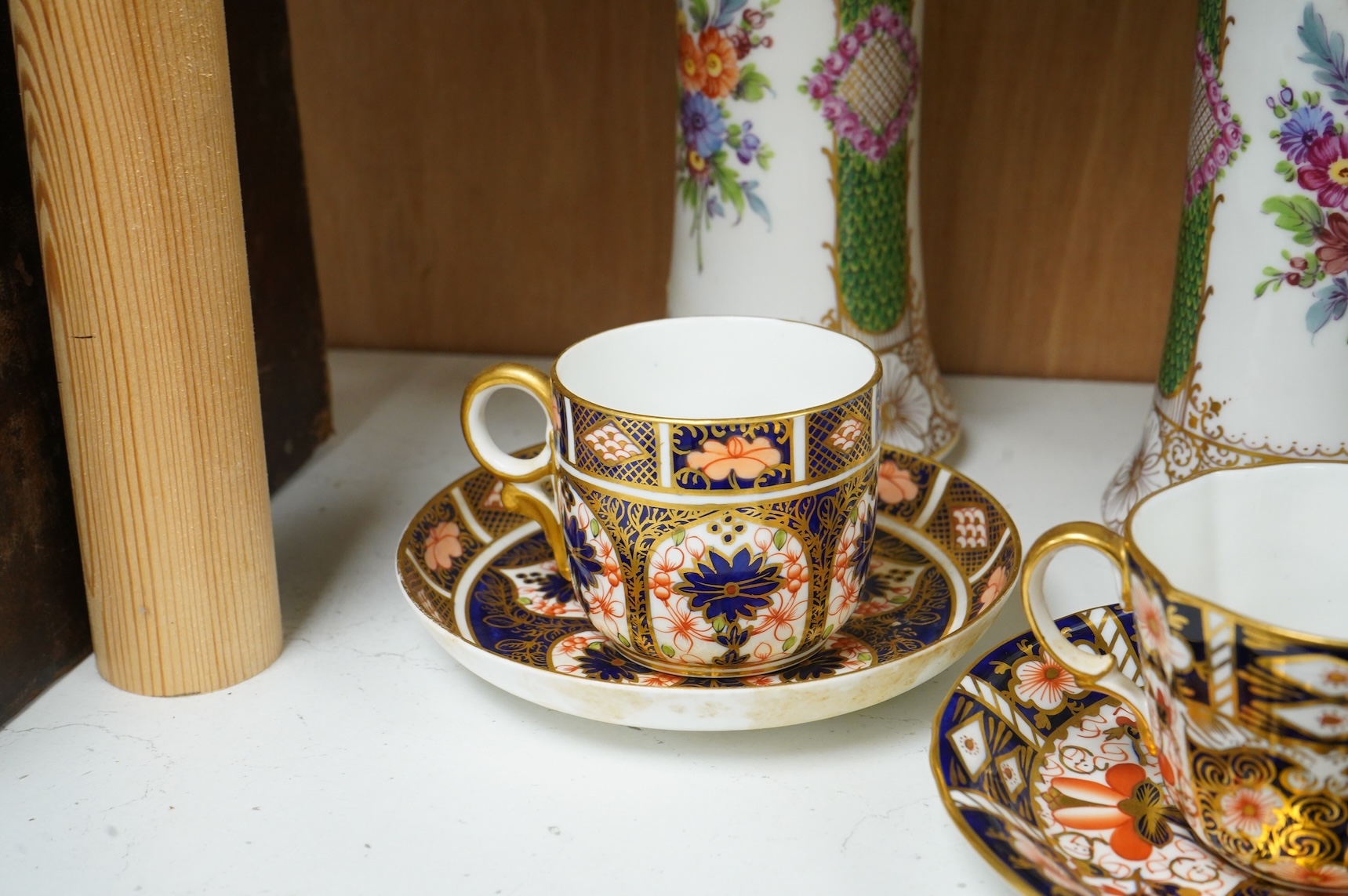 A pair of Dresden vases, a Paris porcelain bottle and stopper, a faience bowl and two Royal Crown Derby cups and saucers, tallest 26cm